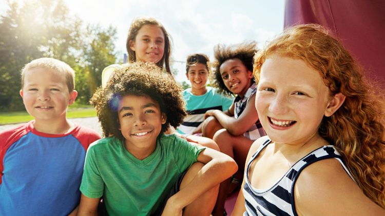 Kids, group and portrait on playground in park to relax with friends in summer. Happy middle school children together for games, smiles, and outdoor activity.