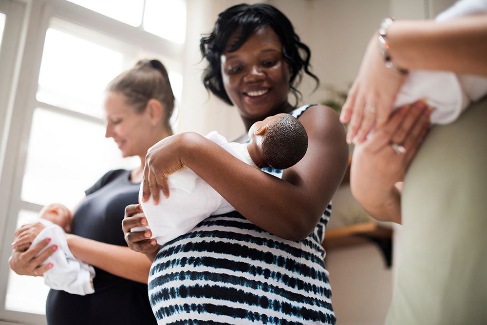 Pregnant woman holding baby doll