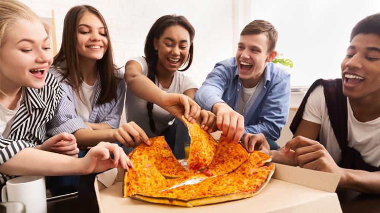 Pizza time. Teen friends sharing food together